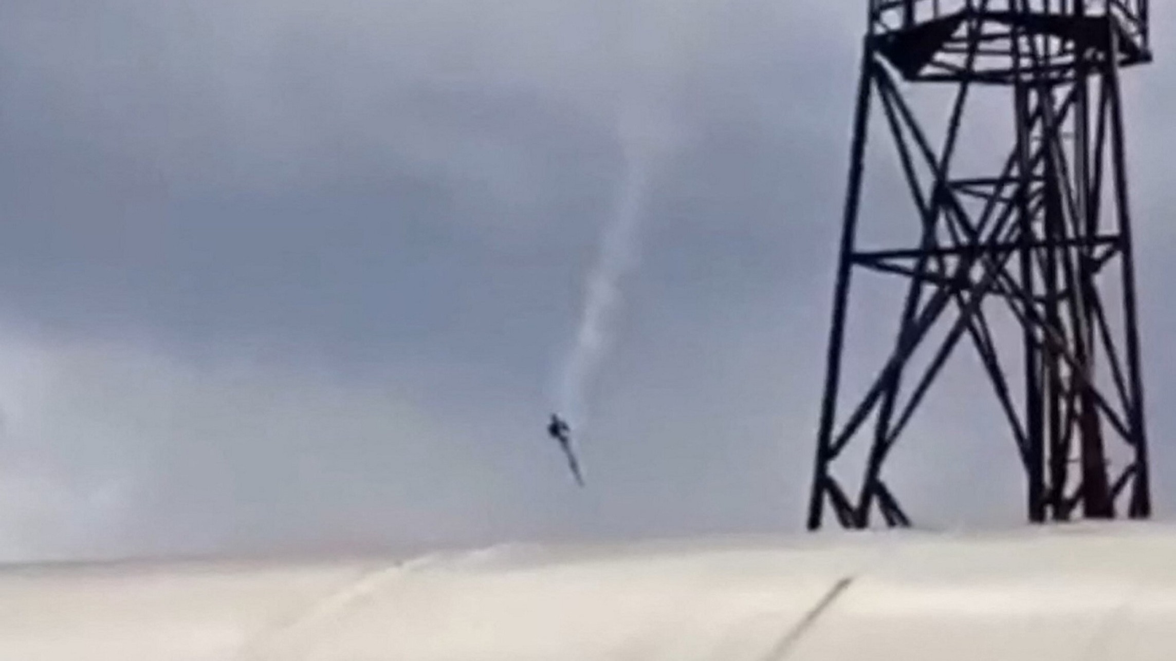 A video grab taken from footage posted on a Wagner-linked Telegram channel shows a plane falling in the sky near the village of Kuzhenkino