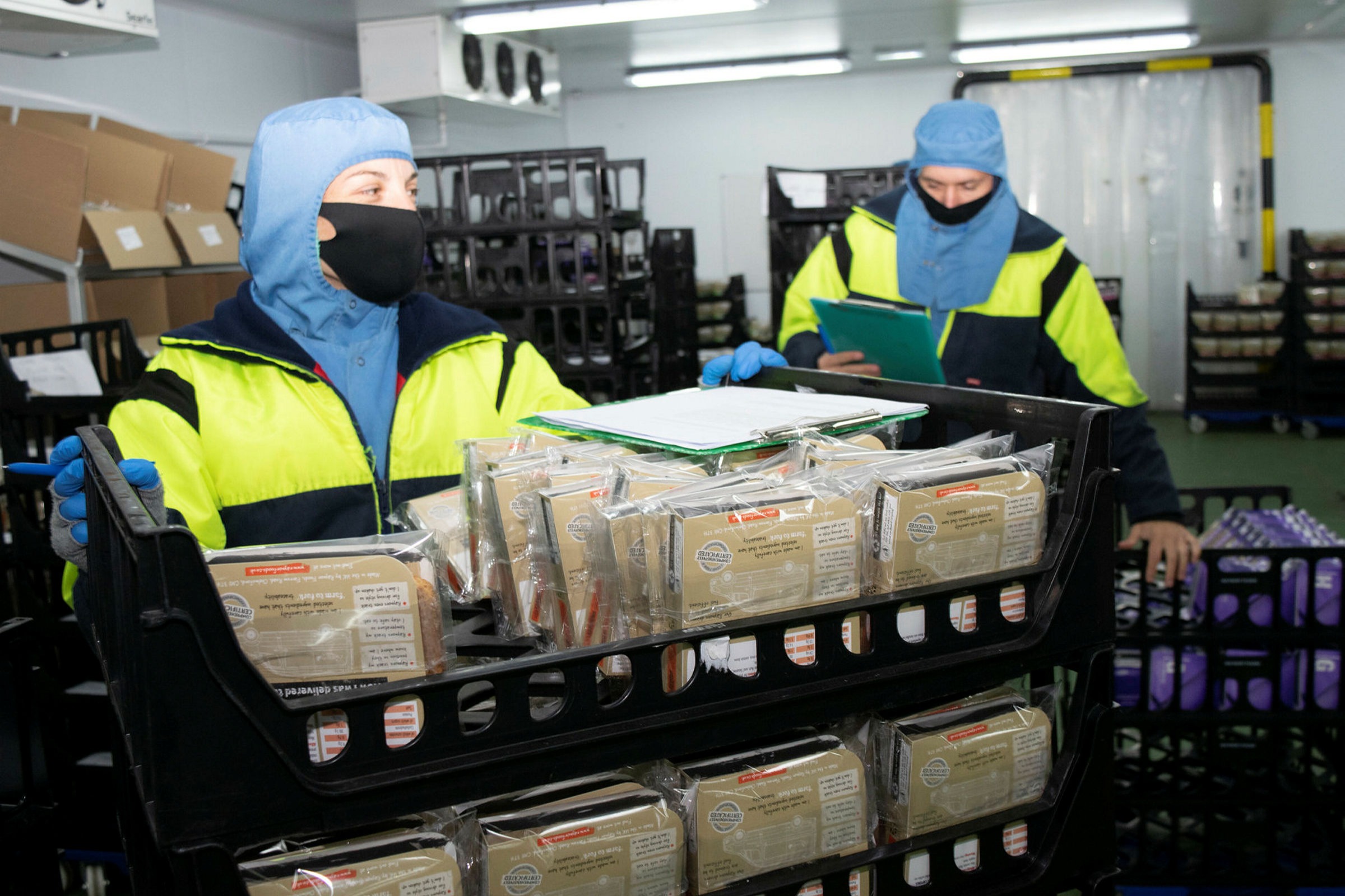 Raynor Foods sandwich makers wear protective gear as they work in a cold room