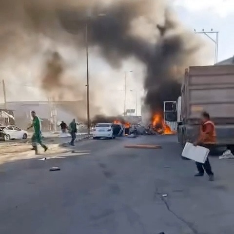 As first responders scramble to help victims, multiple explosions are heard in the background. One nearby blast shakes the ambulance, causing its occupants to get out and run away