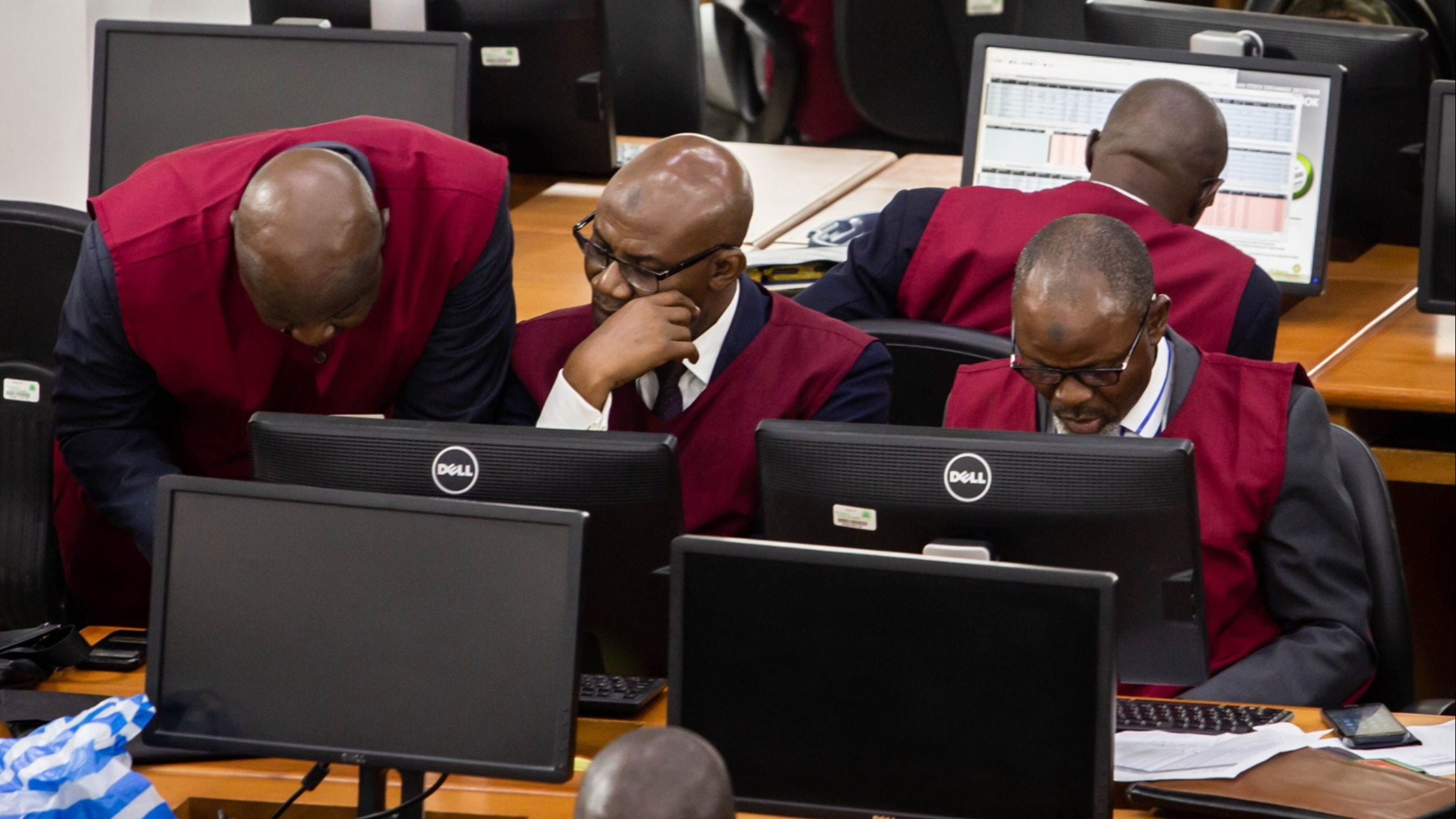 Employees at a stock exchange in Nigeria. The nation’s currency has been stable for more than a year after wild oscillations to record lows last year