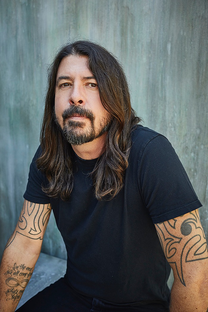 With tattooed arms on full display, Dave Grohl symbolizes the raw and authentic spirit of rock.